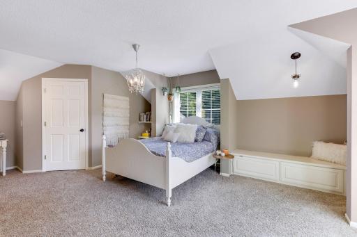 Upper level 3rd Bedroom features charming dormer ceilings, decorative pendant lighting, built-in corner bench and workstation, walk-in closet and private Full Bathroom