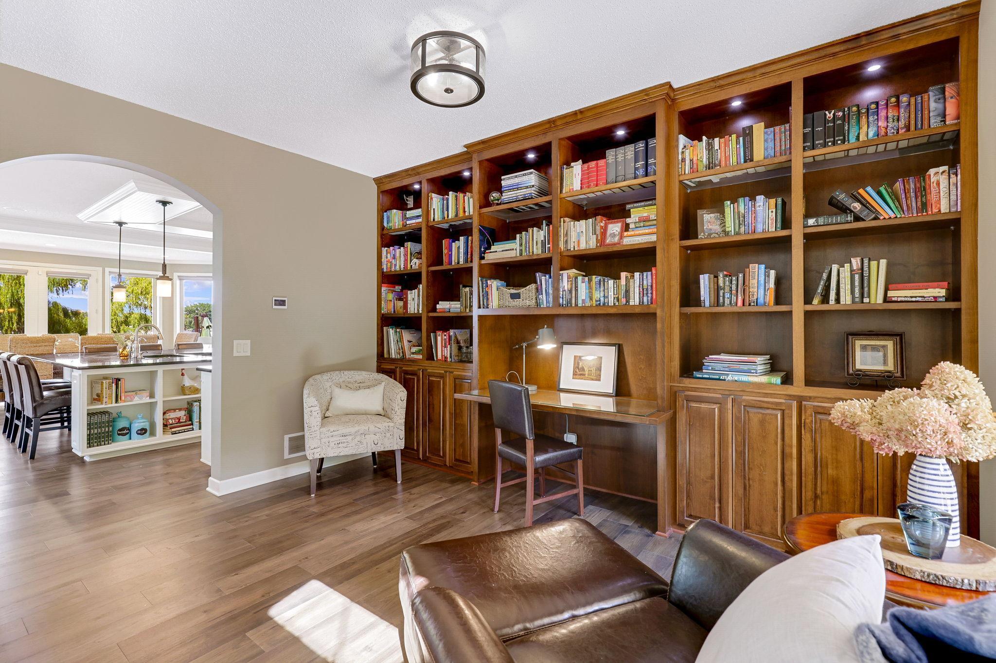 Dramatic floor to ceiling built-in alder bookcase and workstation