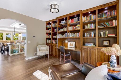 Dramatic floor to ceiling built-in alder bookcase and workstation