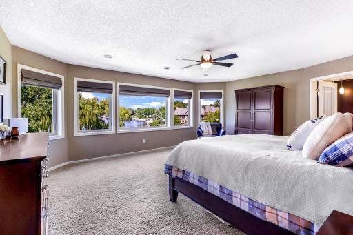 Bay windows capture incredible lake and property views! Large walk-in closet offers professionally installed organizing system, natural light and access to the Laundry Room