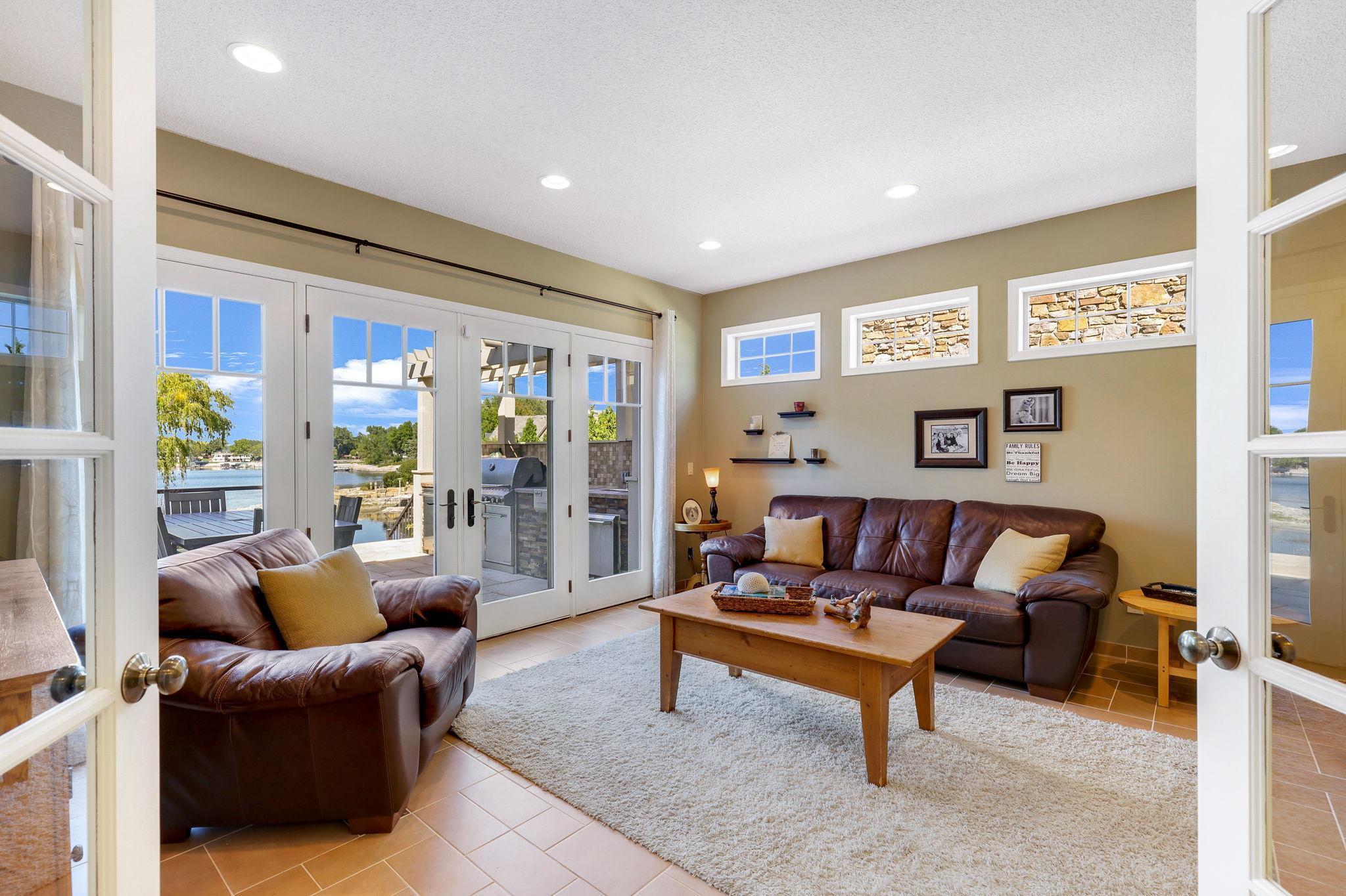 Den offers fantastic lake views and access to the large deck and property