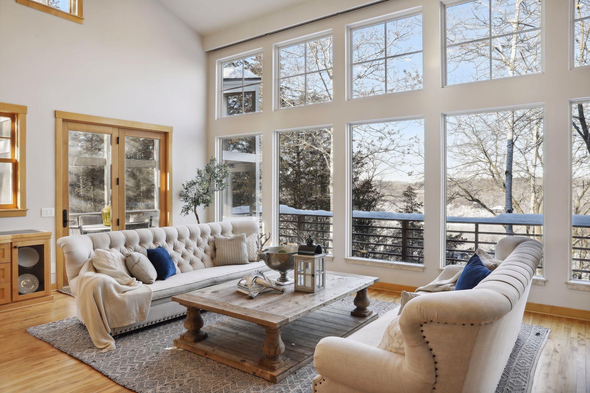 The walls of windows are an every changing picture frame through the seasons. Gather with family and friends in this comfortable space open to the kitchen, and adjacent to the dining room and screened porch. Hidden blinds are powered.