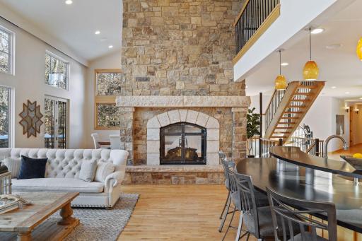 This great room features a floor to ceiling 2-sided gas log fireplace with stunning stone and iron doors. This vaulted space is sure to be the heart of the home.