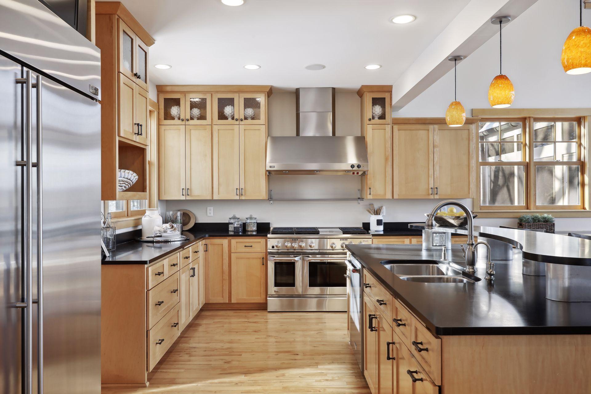 Another view of the kitchen. Upper glass paneled cabinets are lighted.
