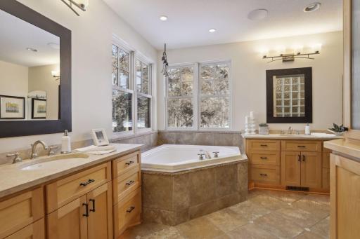 The main level owner's suite features a corner tub and a walk in shower. Dual split vanities and a walk in closet.