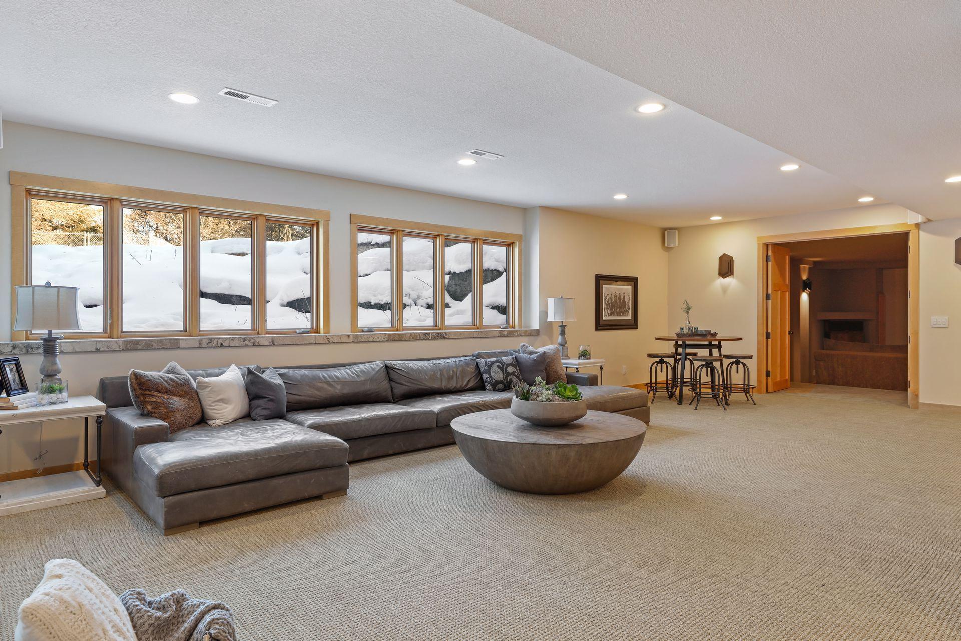 The walkout level is complete with multiple living options including this space which would also be a great space for a pool table or game tables.