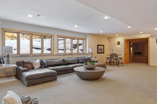 The walkout level is complete with multiple living options including this space which would also be a great space for a pool table or game tables.