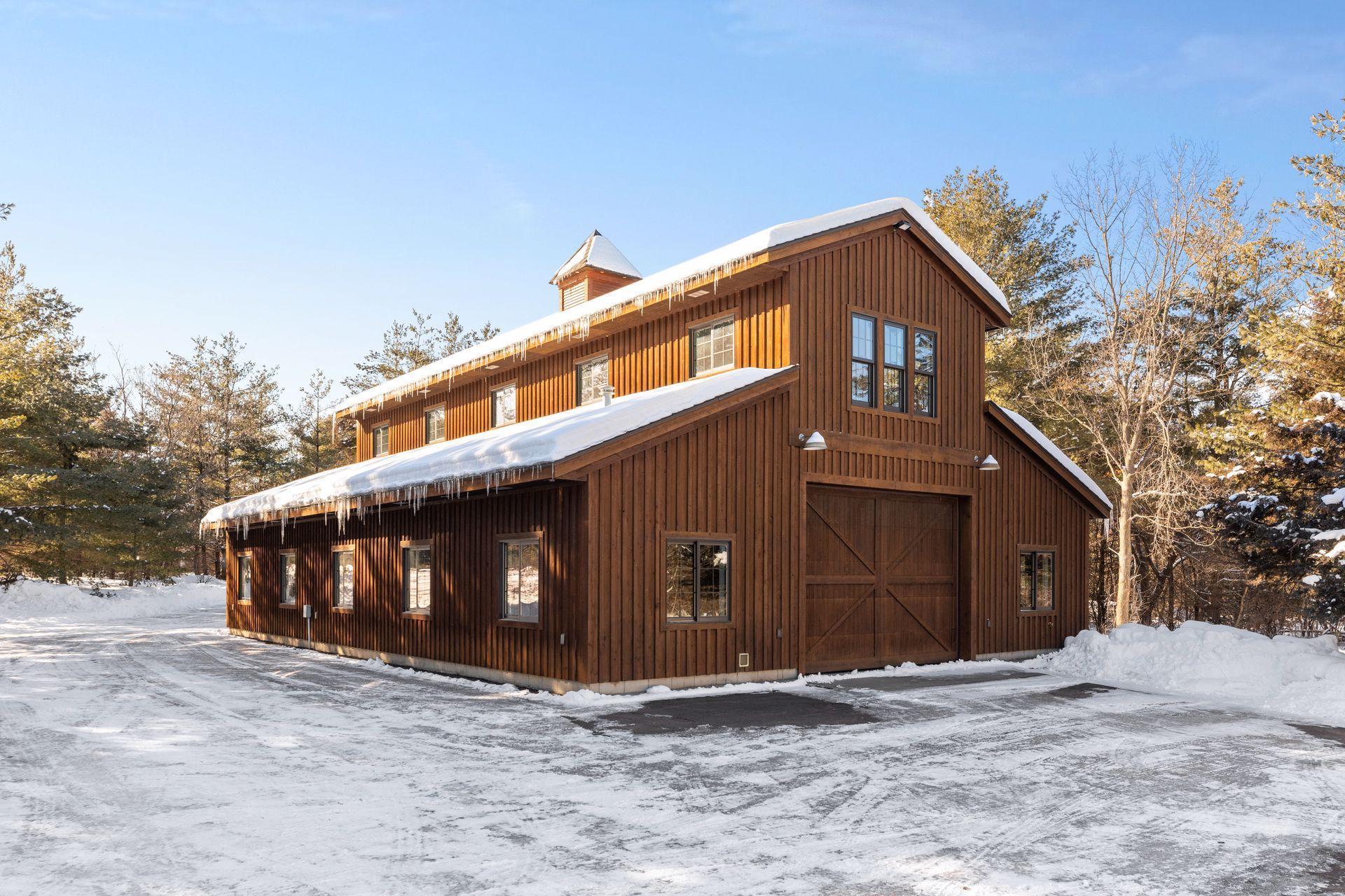 The Barn-this stick built building is 60' x 40' featuring concrete floors, electric, heat and a newly installed well. 2-10' doors on each end of barn, and 2-8' doors on one end. Upper level was just completed as a climate controlled home gym.