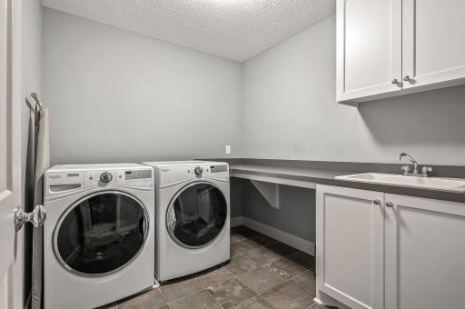 Upper level laundry room with plenty of storage space