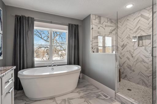 Separate walk in tile shower with custom glass door