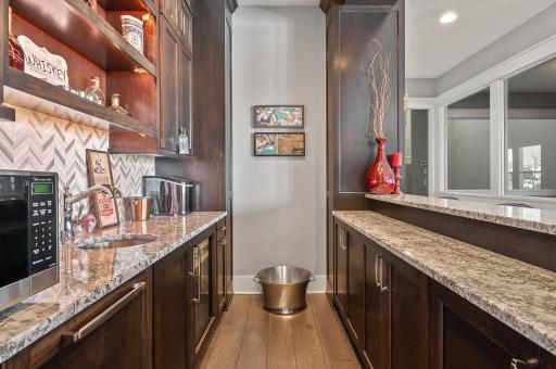 Full custom bar features dishwasher, microwave & beverage cooler