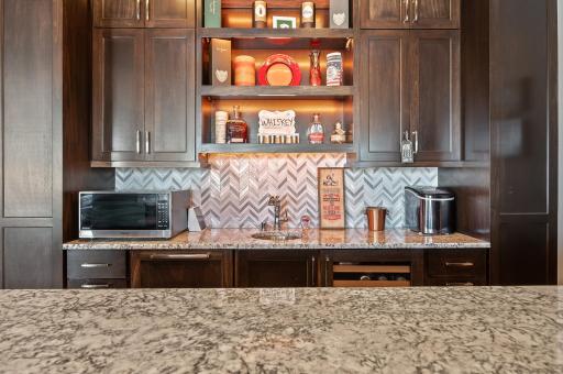 Cambria countertops, under cabinet lighting make this bar a complete show stopper