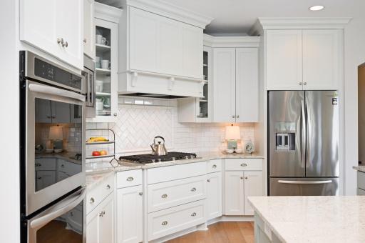 A gourmet kitchen with double convection ovens, granite countertops, and stainless steel appliances.