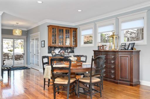 There is an adjacent walnut bar with a beverage refrigerator and glass cabinets