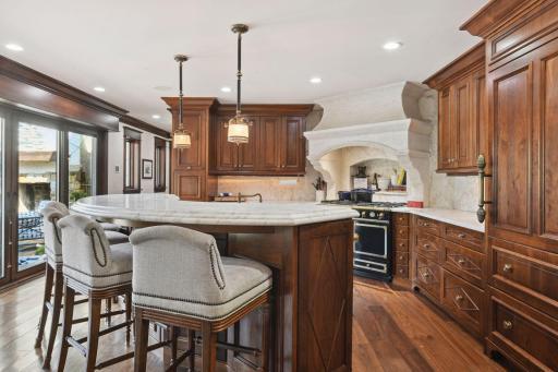Walnut Cabinetry and Carrera Gold Marble Countertops