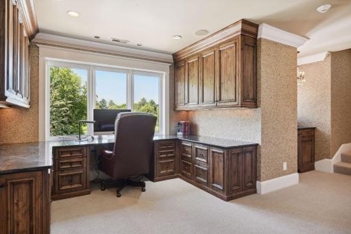 Loft Area with Built-In Desk Overlooking Backyard