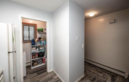 Kitchen is right off the entry and has in-unit laundry with small pantry at the back of it.