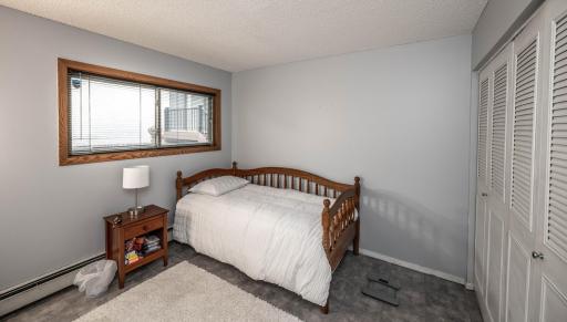 Bedroom #1 with large closet and tile floors. Great for a guest space & to double as an office!