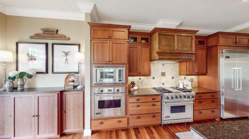 SS Viking appliances including a double door refrigerator, wall oven & microwave, and gas stove with 4 burners & griddle