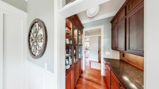 Butler Panty has cherry hutch & cabinetry with Cambria counter tops. Lighting located in the hutch & under cabinets