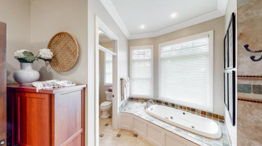Separate jetted tub with slate tile surround