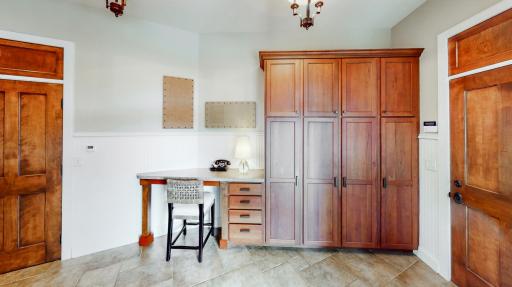 Mud room from garage with ceramic tile & in-floor heat. Cherry cabinetry & desk.