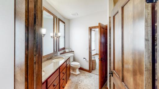 Jack and Jill Bathroom with tiled floor & 4-panel birch doors