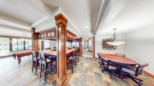Game room off bar area that is 13' x 11' with hallway leading to bedrooms & Flex room