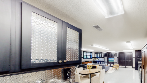 Flex Room/lower garage with Diamond Steel cabinets & walls. Equipped with steel counter, cabinets, sink & beverage refrigerator.