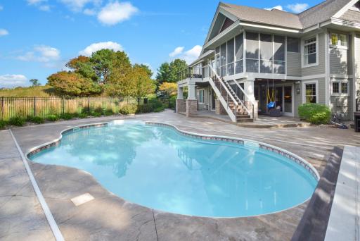 Salt water pool surrounded with stamped concrete patio. New automatic pool cover installed in 2017 for safety & convenience. New pool heater 2022.