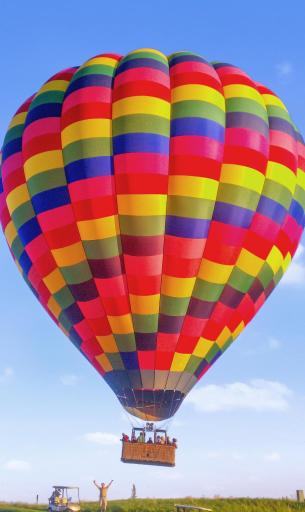 A beautiful warm summer day on golf course and a hot air balloon came down on the 9th hole.