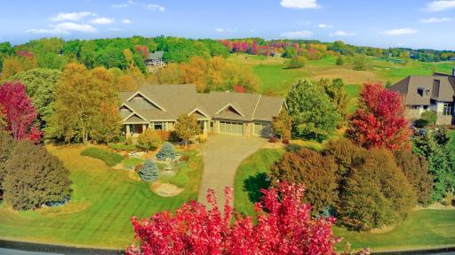 Fall view of home & neighborhood with golf course directly behind.