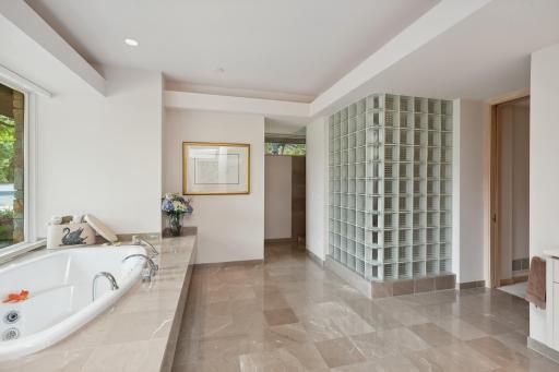 Relax and unwind in the oversized tub after a lovely walk through nearby Hyland Park. There is a glass block walk-in shower to complete this sophisticated space.