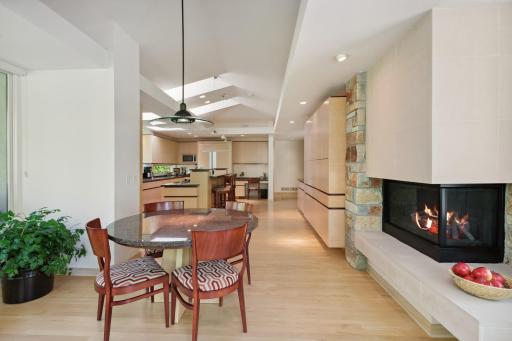This space is warmed by the ambiance of the two-sided gas fireplace.