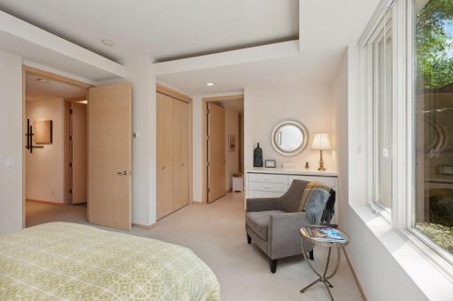 The second lower level suite also offers a private bath with shower, large vanity, ceramic tile floors, and walk-in closet.