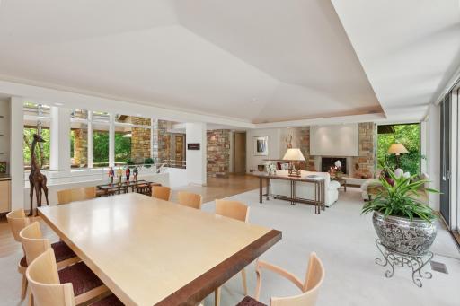 Enjoy the talking points of custom soffits blended into a mesmerizing ceiling vault from three angles, floor-to-ceiling fireplace set in ceramic tile with stone wall accents, and dining room vertical stone wall.