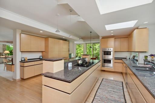 Allow the meandering maple floors to lead you around this spacious kitchen to the large informal dining space.