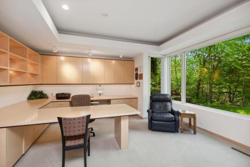 A few steps away is a private office with built-in cabinets and desk entered by dual French doors.