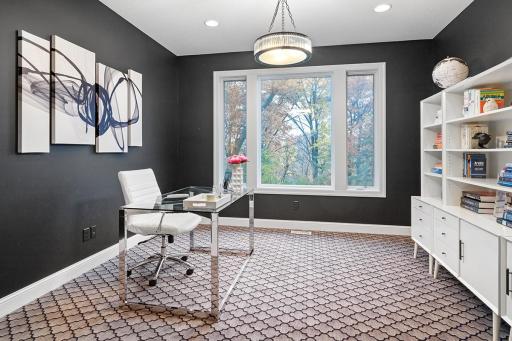 Office, away from the main living space for quiet privacy (double pocket doors)