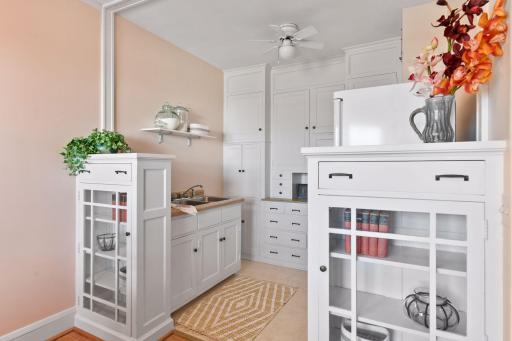 Immaculate original wood built-ins separate the dining room from the kitchen.