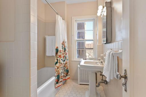 An original bathroom marble window sill and floor trim was discovered when painting and was brought back to add to the character of this unit!