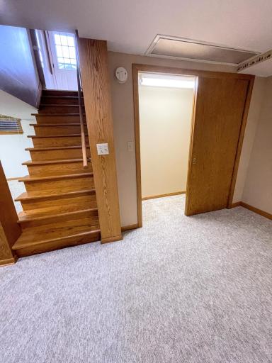 Beautiful hardwood stairs lead down to the Lower Level with ALL NEW FLOORING in the Family Room Areas (notice more than one!)