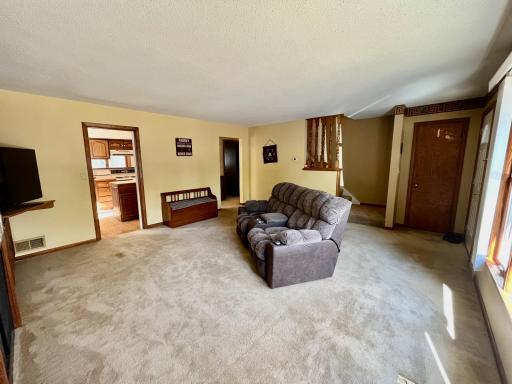 Living room with pocket door to kitchen