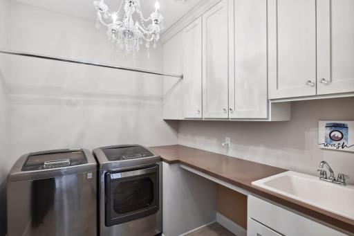 2nd flr. laundry room w/folding counter, hanging rod, and built-in cabinets
