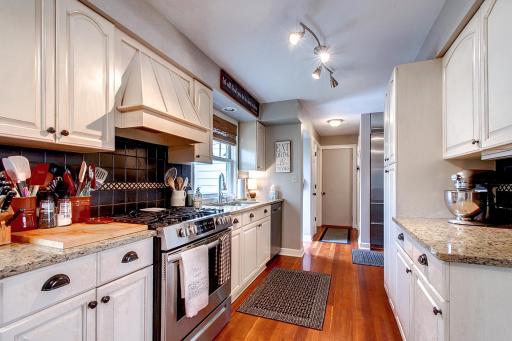 Efficient and highly functional kitchen with gas range, granite countertops and an abundance of cabinets