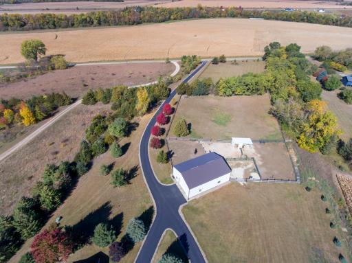 Aerial view of 54 x 36 Pole shed and adjoining horse arena area. Front half of shed is heated with concrete floor and office area.