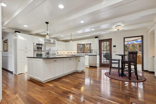 Attractive Main Floor Kitchen with Breakfast Bar and Beautiful Granite Countertops