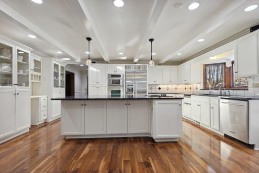 Kitchen Features Glowing Hardwood Floors, an Abundance of Cabinetry and Stainless Steel Appliances