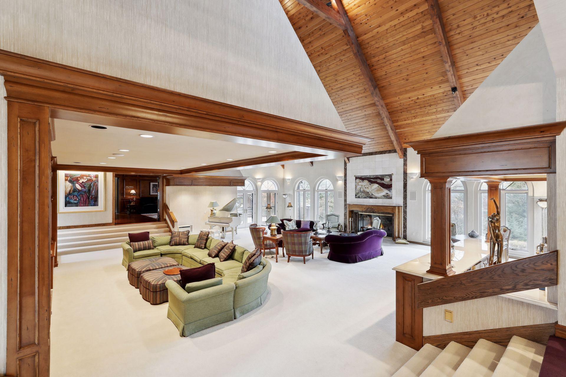 Main Living Room with Floor to Ceiling Grand Fireplace, Bar Area, and TV Area