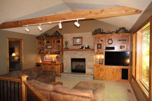 Stone accents surround Gas Fireplace
Vaulted Ceiling with Cedar Beam